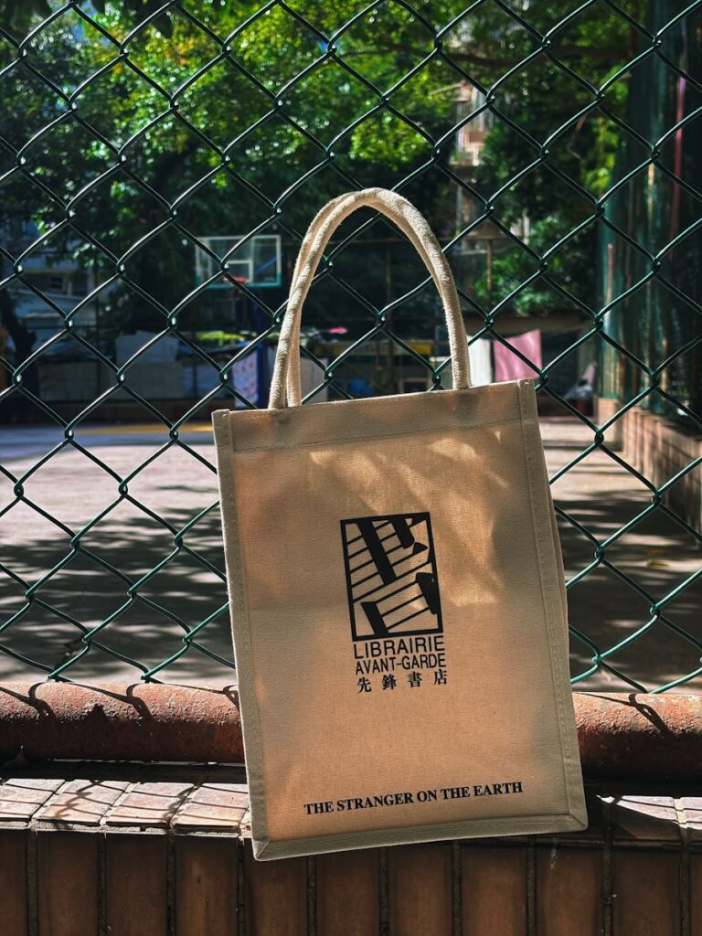 A canvas tote bag with a logo and text.